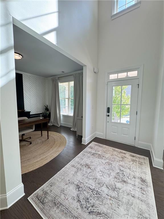 Entrance foyer featuring baseboards, a towering ce