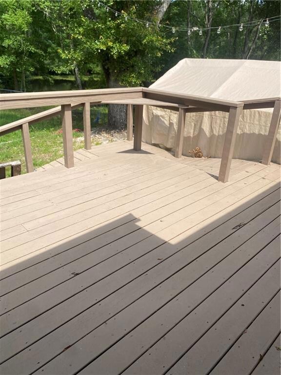 Wooden deck with view of wooded area
