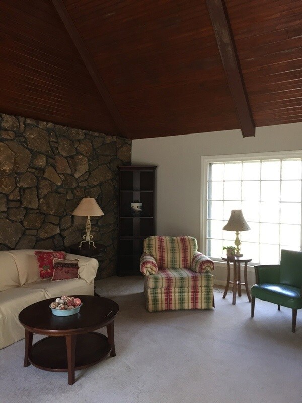 Another view of living room with bright picture wi