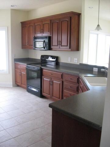 Kitchen has custom Cherry Cabinets