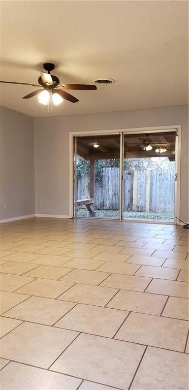 Spare room featuring a ceiling fan, baseboards, a