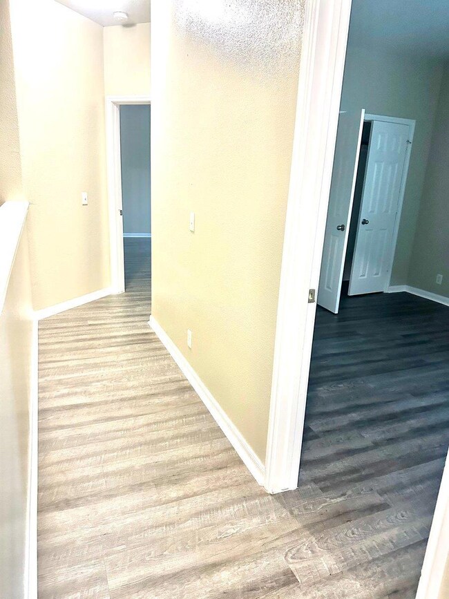 Corridor with wood finished floors and baseboards