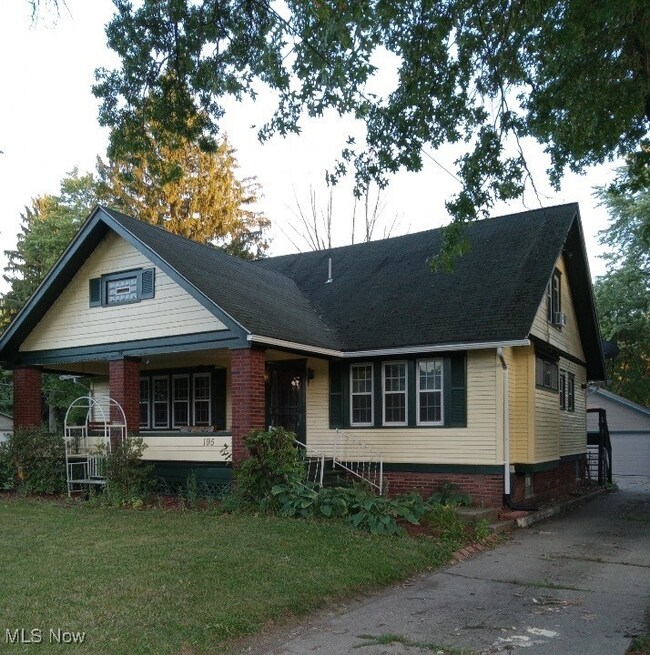 View of front of home featuring a garage and a front yard