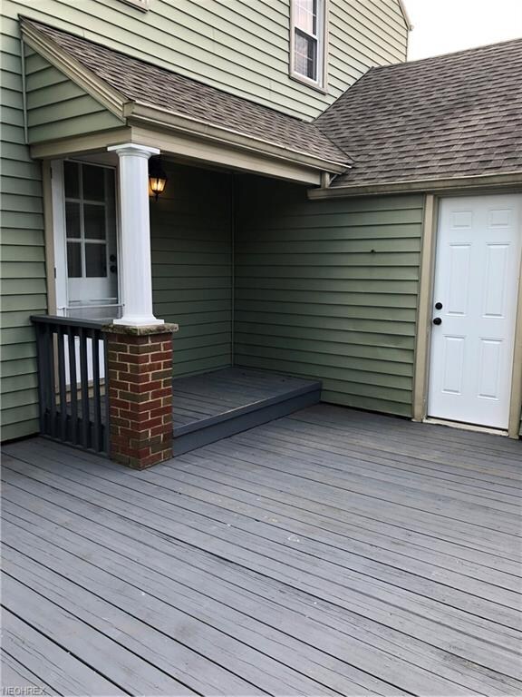 Covered porch with door to kitchen and door off of