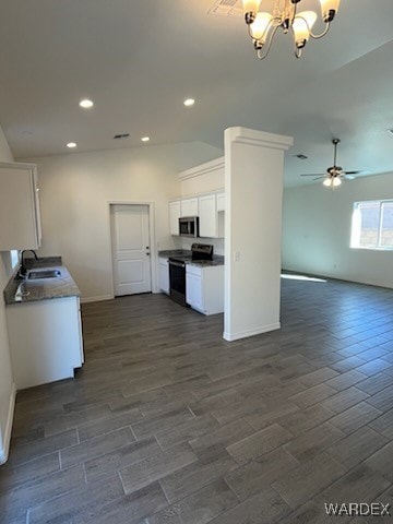 Kitchen featuring white cabinetry, sink, dark wood