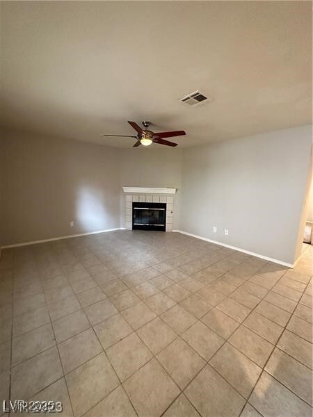 Unfurnished living room featuring baseboards, ligh