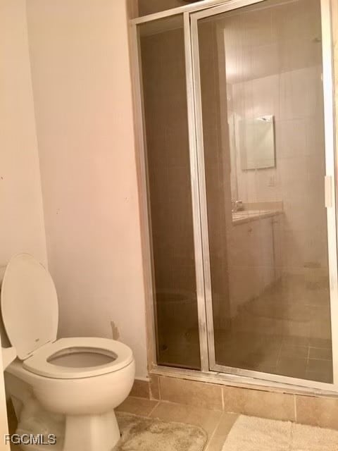 Full bath with a stall shower and tile patterned floors