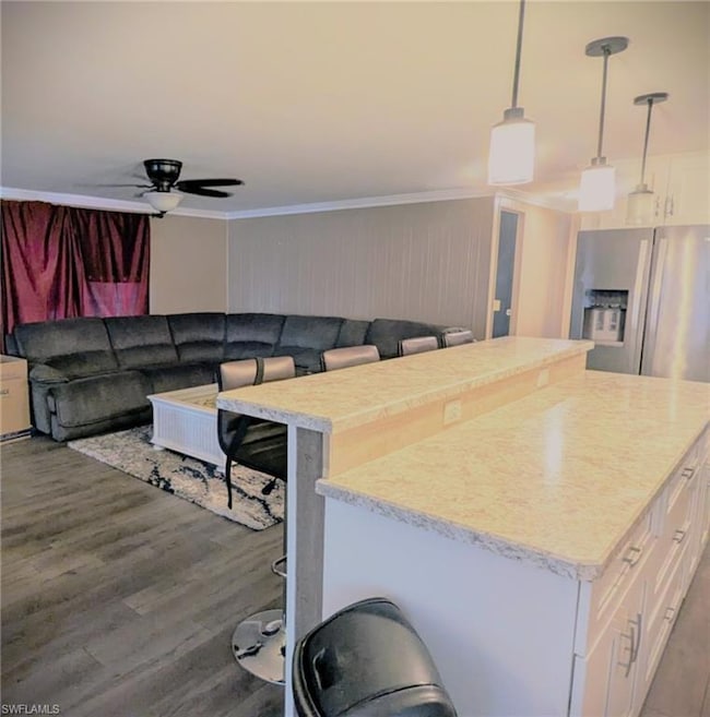 Kitchen featuring a kitchen island, white cabinetr