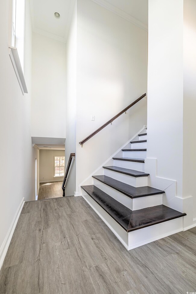 Staircase with hardwood / wood-style floors and or