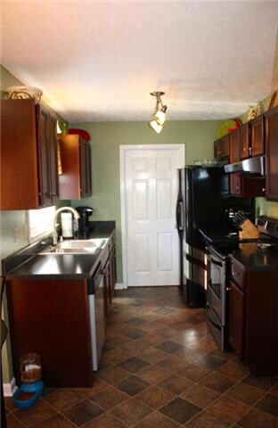 Kitchen with door leading to garage for easy grocery unloading.