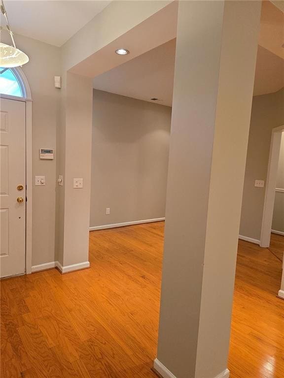 Entry and dining room featuring baseboards, recessed lighting, and wood finished floors