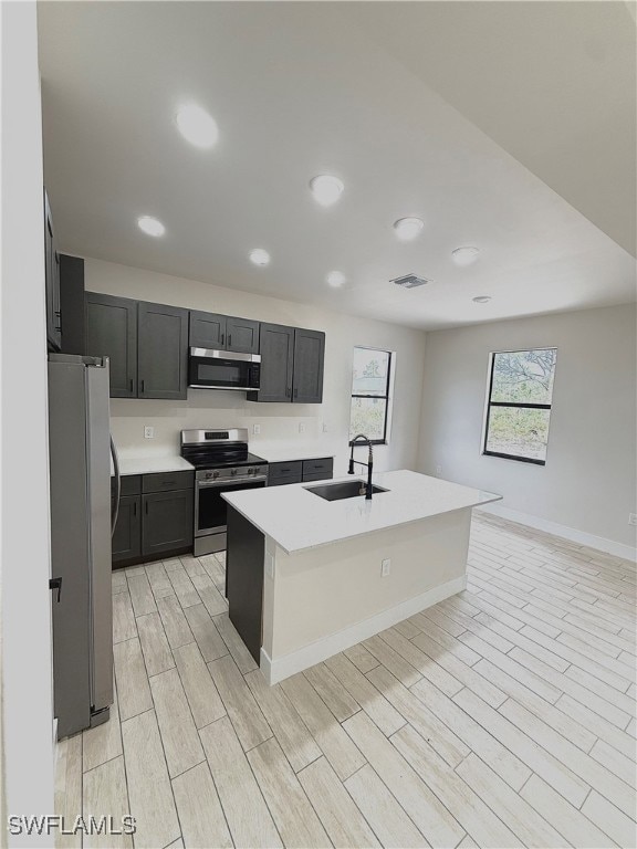 Kitchen with stainless steel appliances, a sink, w