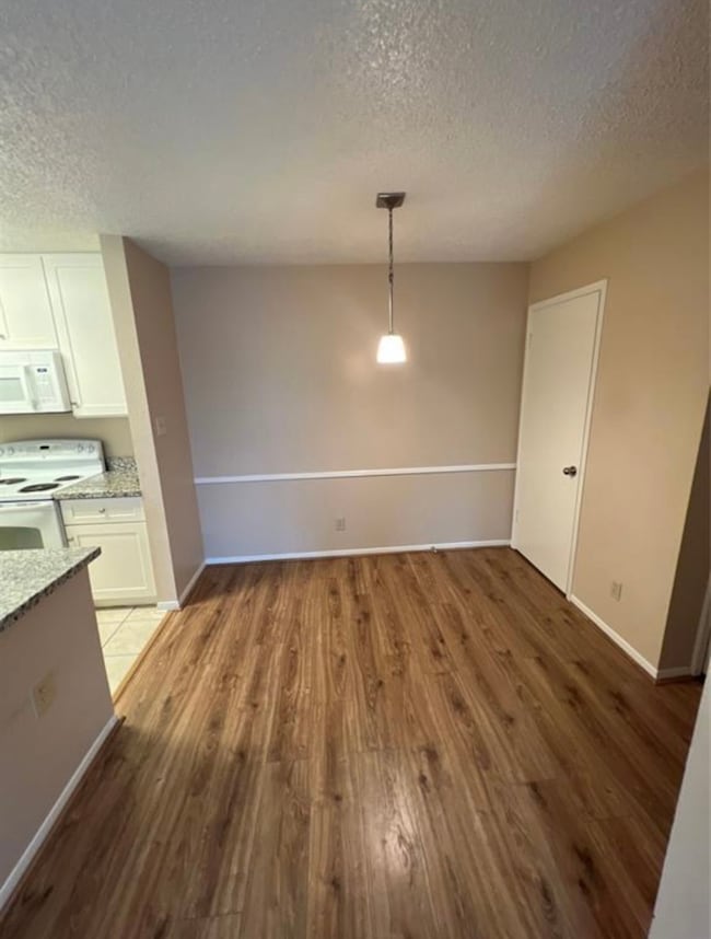 This photo shows a cozy dining area with wood floo
