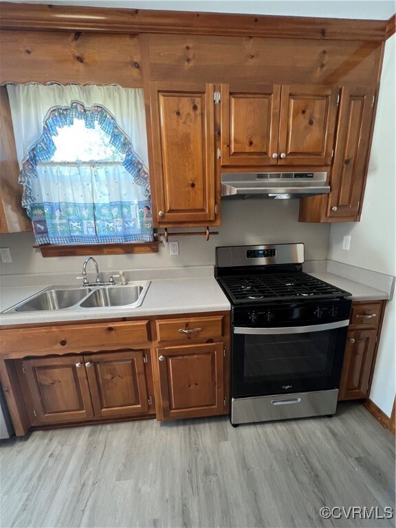 Kitchen featuring range hood, light hardwood / woo