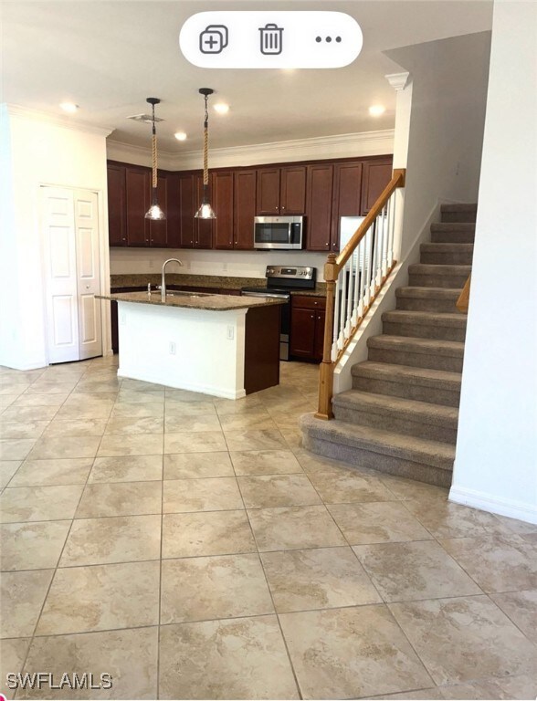 Kitchen with a sink, ornamental molding, appliance