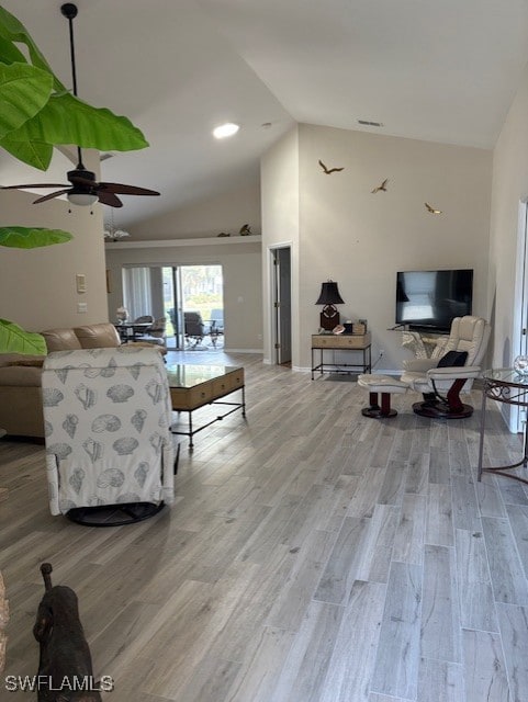 Living area featuring high vaulted ceiling, light