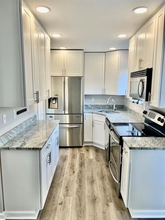 Kitchen featuring light stone countertops, applian