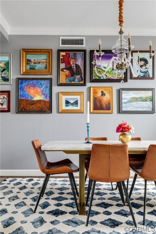 Dining room featuring a chandelier and crown moldi