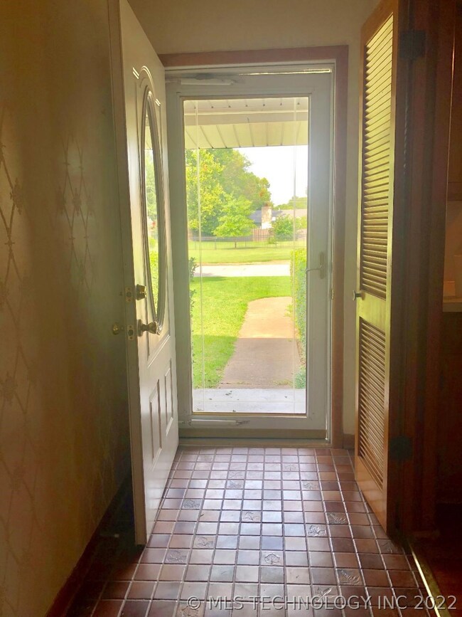Entry way, kitchen enters to the right