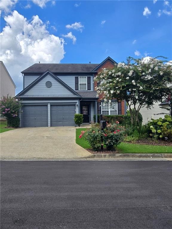 Traditional-style house with driveway and a garage