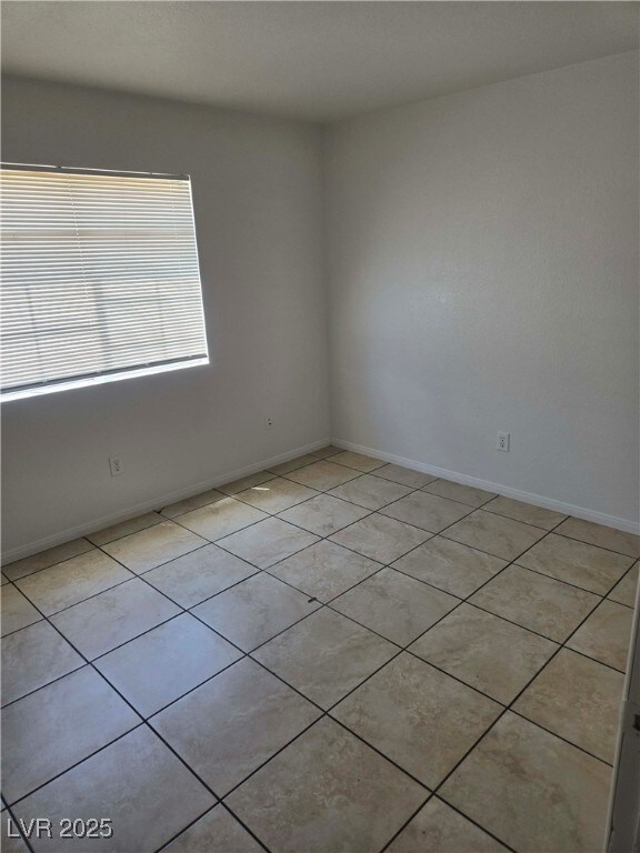 Spare room featuring light tile patterned flooring