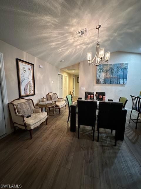 Dining room with vaulted ceiling, a chandelier, an