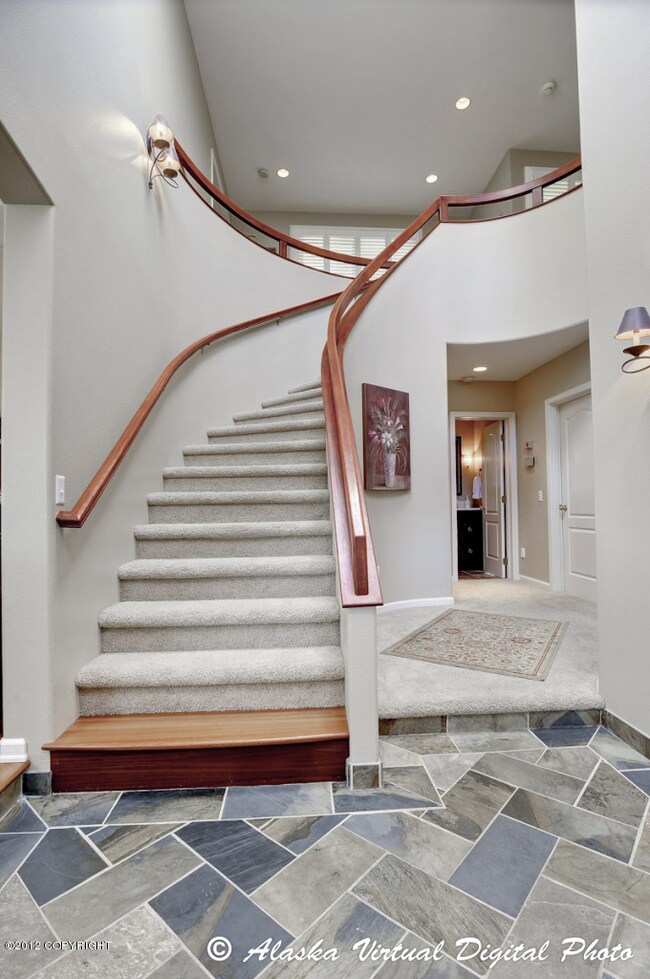 Staircase and tiled main entry floor