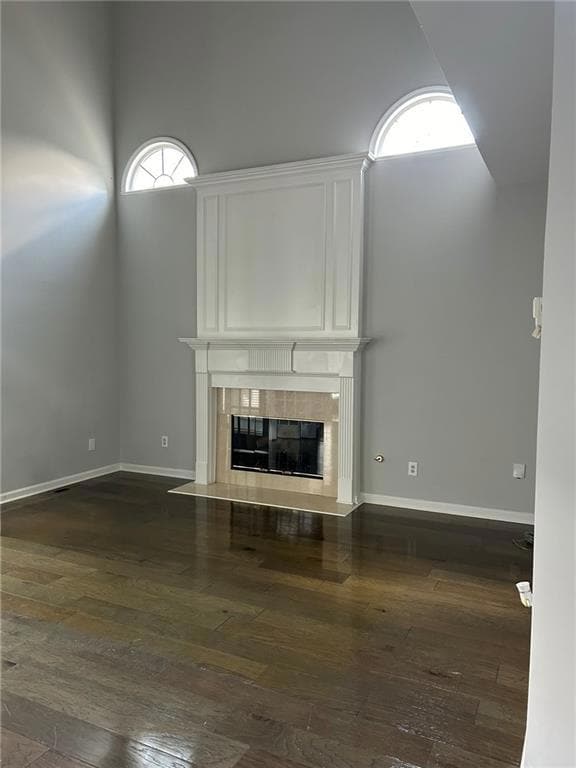 Unfurnished living room featuring hardwood / wood-