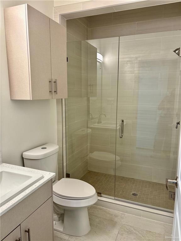 Bathroom featuring vanity and a stall shower