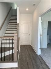 Hallway featuring stairs, wood finished floors, and recessed lighting