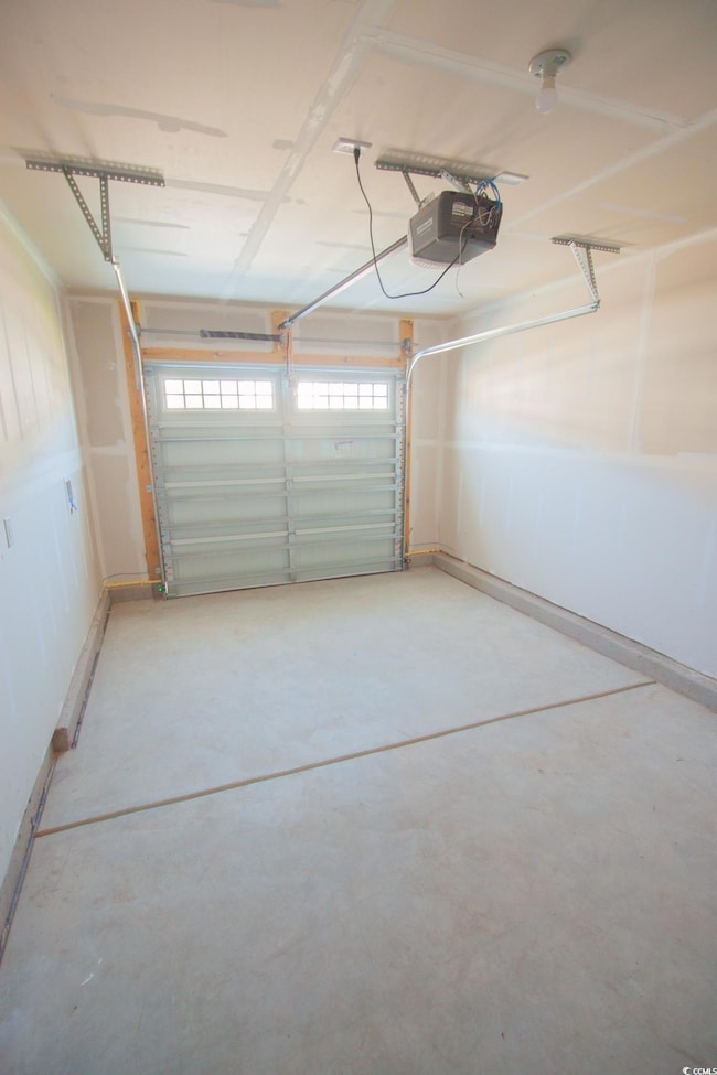 Garage featuring a garage door opener