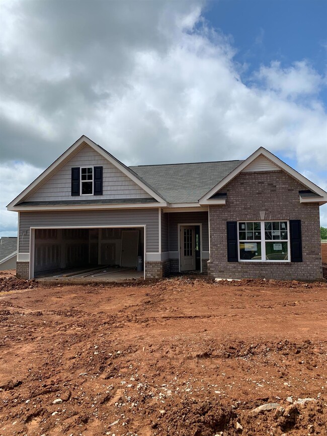 Exterior of actual Lanier floor plan. Home offers 9 ft ceilings and a wide foyer.