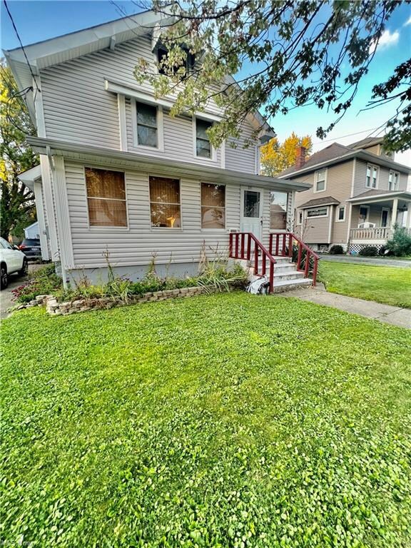 View of front of home with a porch and a front law