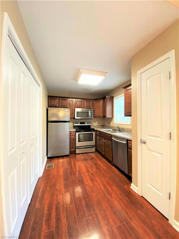 Kitchen with pantry and doors to laundry area