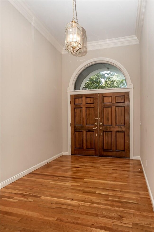 Hardwood foyer with double opening doors.