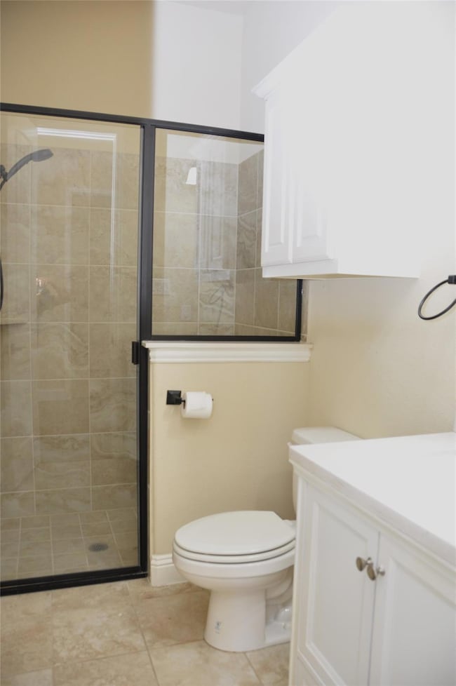 Bathroom with walk in shower, tile patterned floor