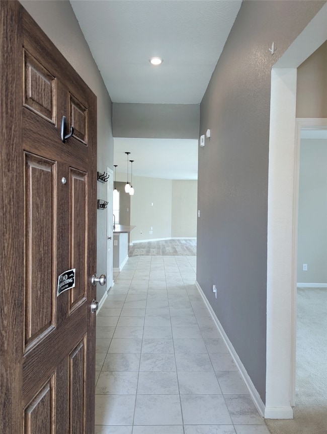 Formal entry with wood insulated door and tile flo