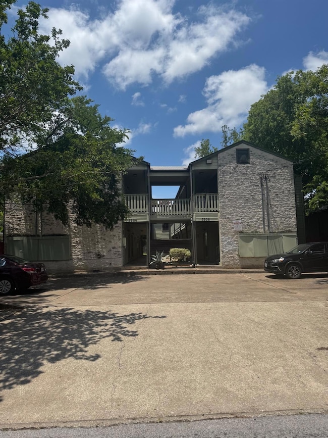 View of property featuring uncovered parking
