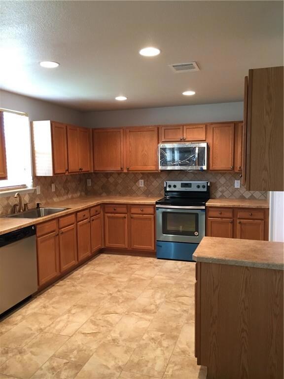 Kitchen with SS sink and dishwasher. New tile floo