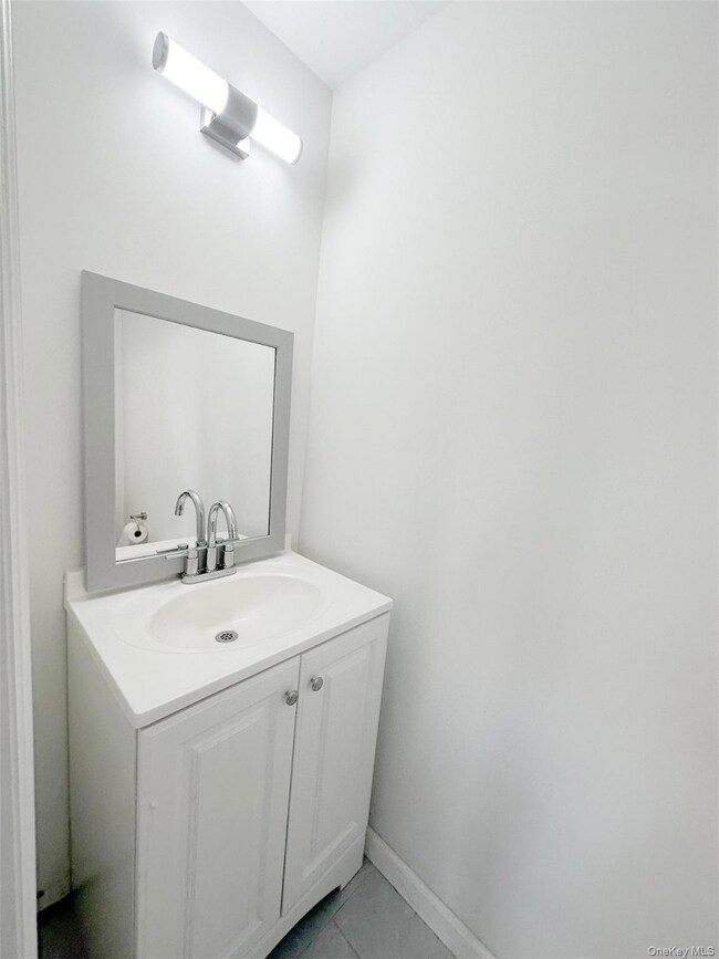 Bathroom with vanity and light tile patterned floors