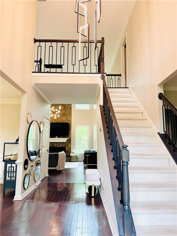 Entrance 2 story foyer featuring crown molding, hardwood / wood-style flooring, and stairway