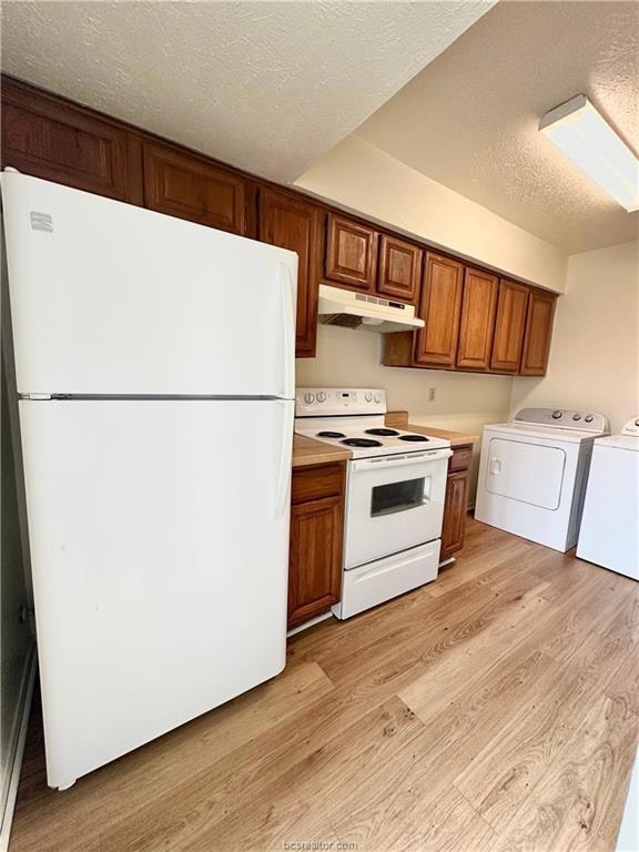 Kitchen featuring washer and clothes dryer, light