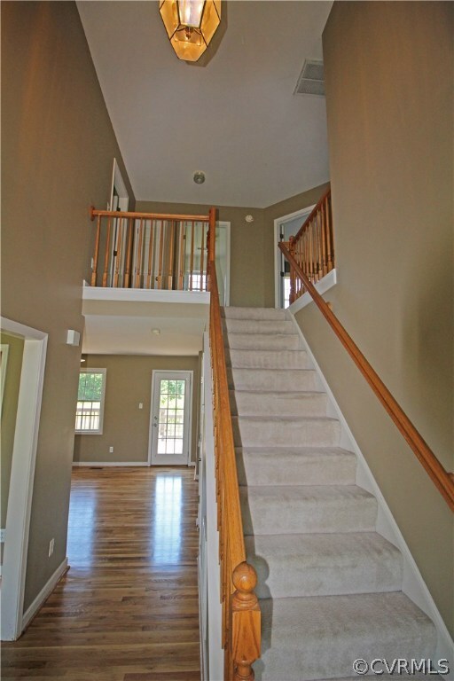 The two story foyer features refinished hardwood,