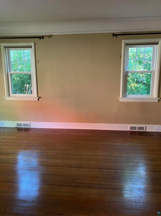 Spare room with dark hardwood / wood-style floors 