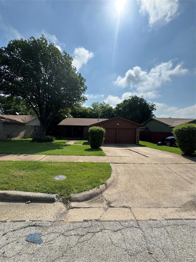 Ranch-style house with a garage and a front yard