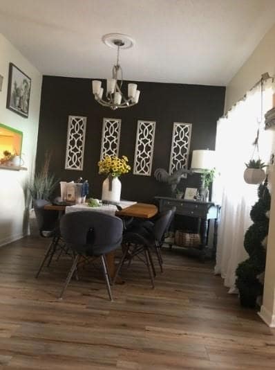Dining area with an inviting chandelier and wood f