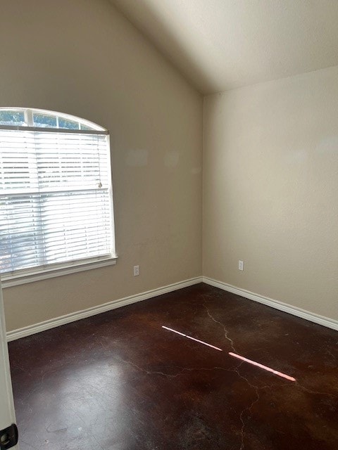Spare room with lofted ceiling and baseboards