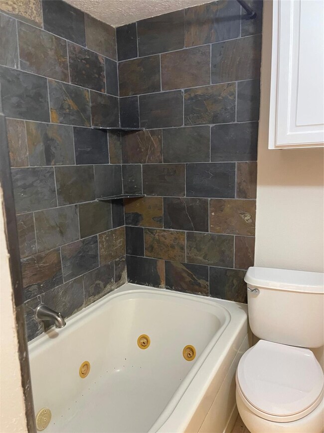 Full bathroom with vanity, washtub / shower combin