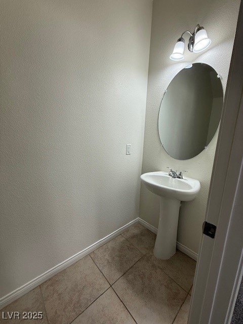 Bathroom featuring tile patterned flooring and bas