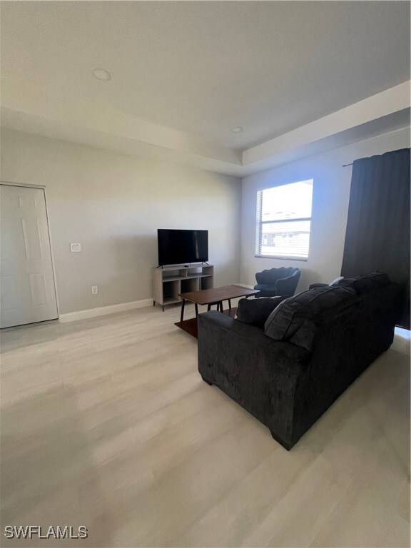 Living room with light hardwood / wood-style floors